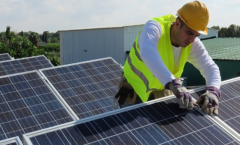 repairing solar panels on rooftop